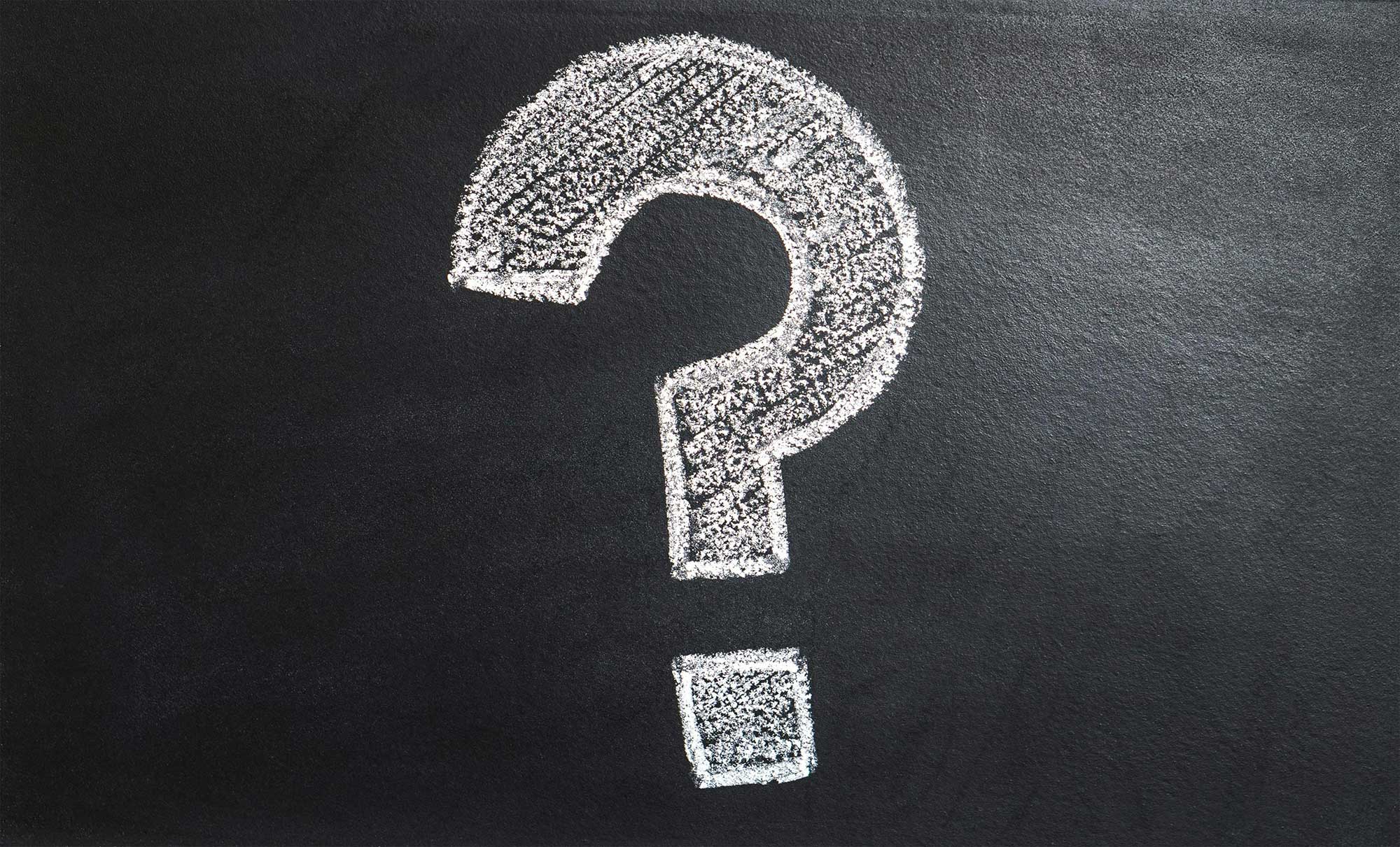 A large question mark drawn on a chalk board.