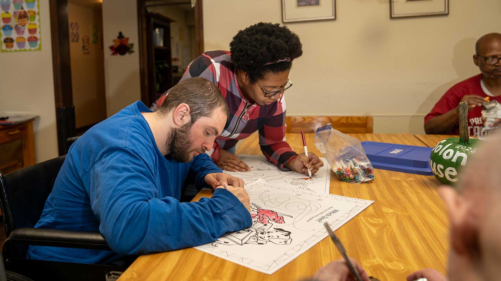 A non-profit worker helps a client with intellectual and developmental disabilities.