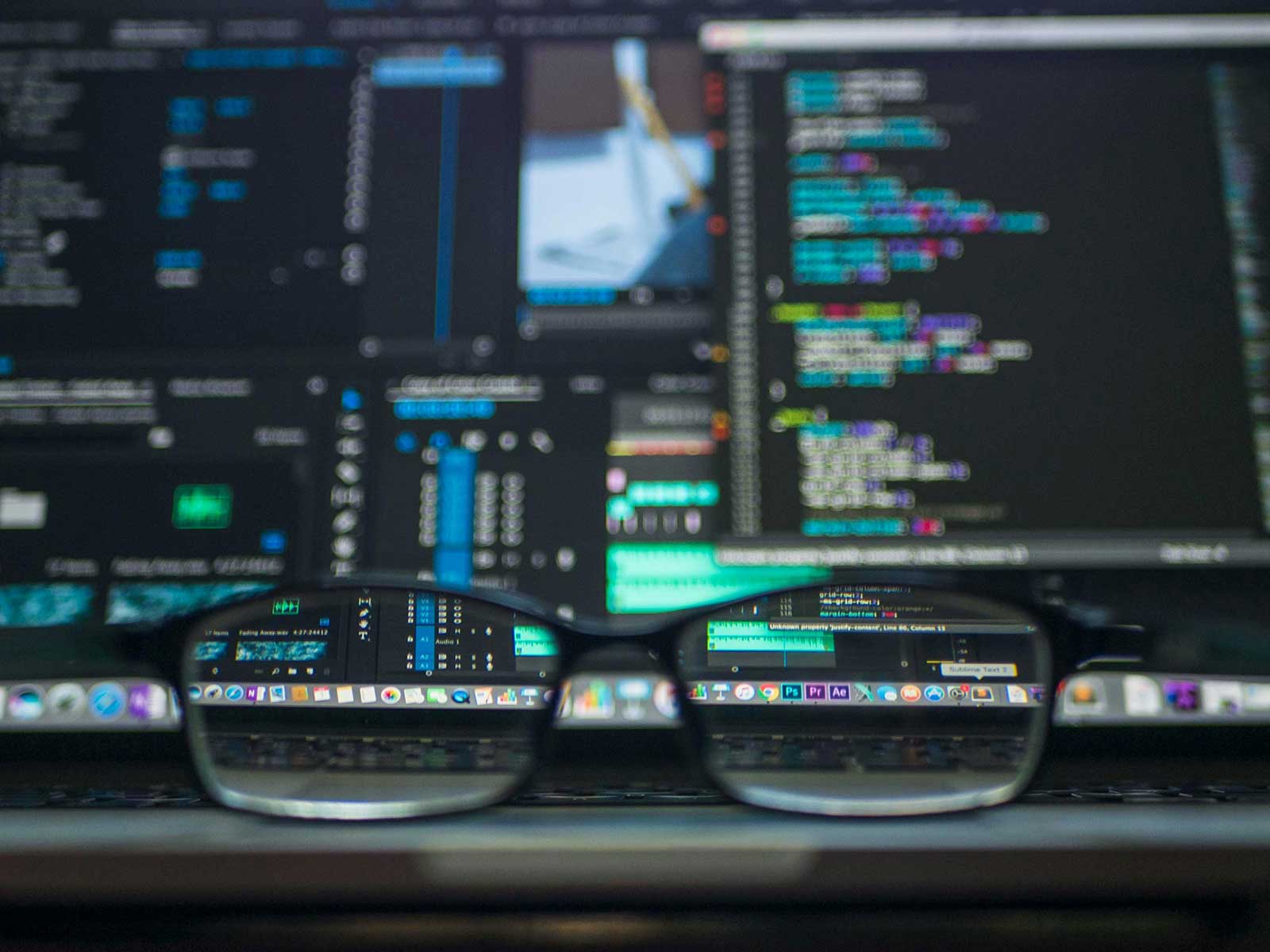 Glasses in front of a computer screen with an AI in the background.